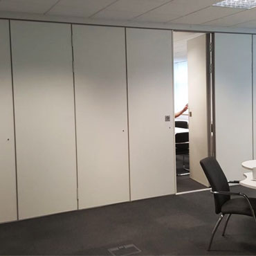 Sliding folding partition system in modern office for flexible space management
